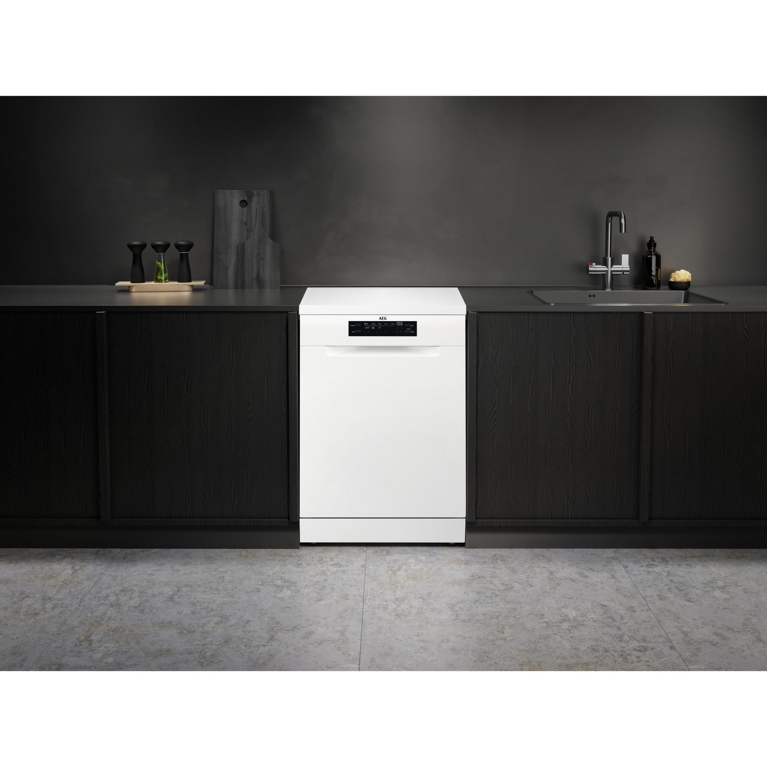 White dishwasher in a kitchen. Black cabinets and a gray countertop.