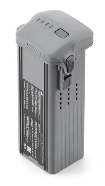 Szara bateria drona z przyciskiem, kontrolkami i etykietą z tekstem.