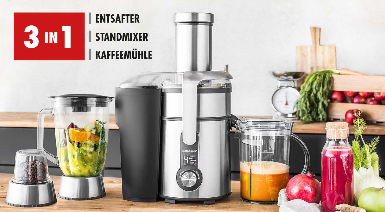 Entsafter, Mixer und Mahlwerk auf einer Theke mit Früchten. Roter Text sagt 3 in 1.