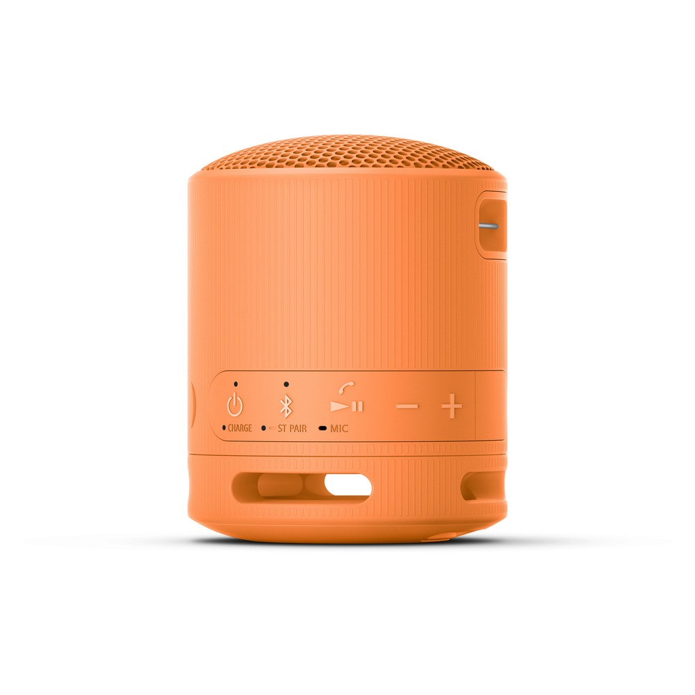 Altavoz cilíndrico naranja con botones y logotipos en la parte frontal. El altavoz se encuentra sobre una superficie blanca.