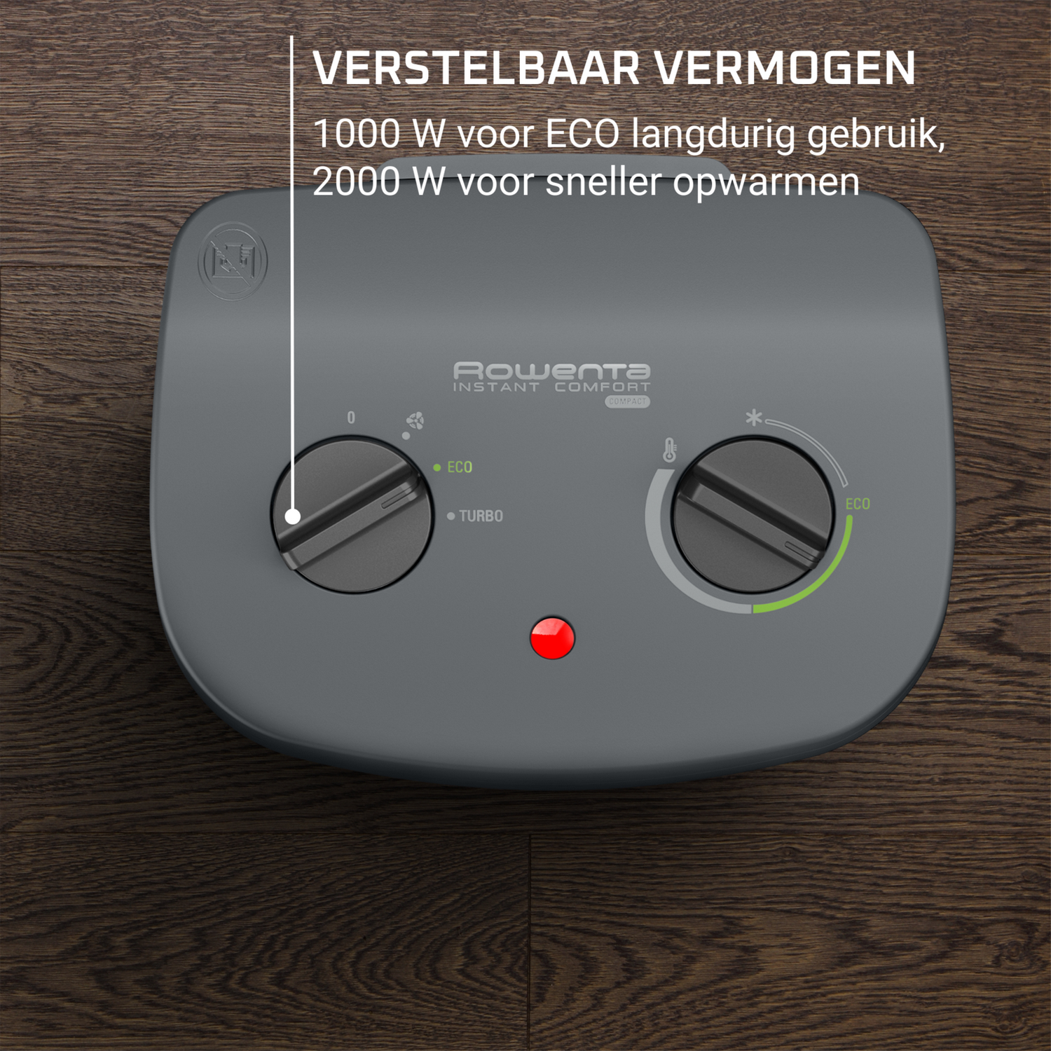 Close up of a grey heater with dials and a red light on a wooden surface.