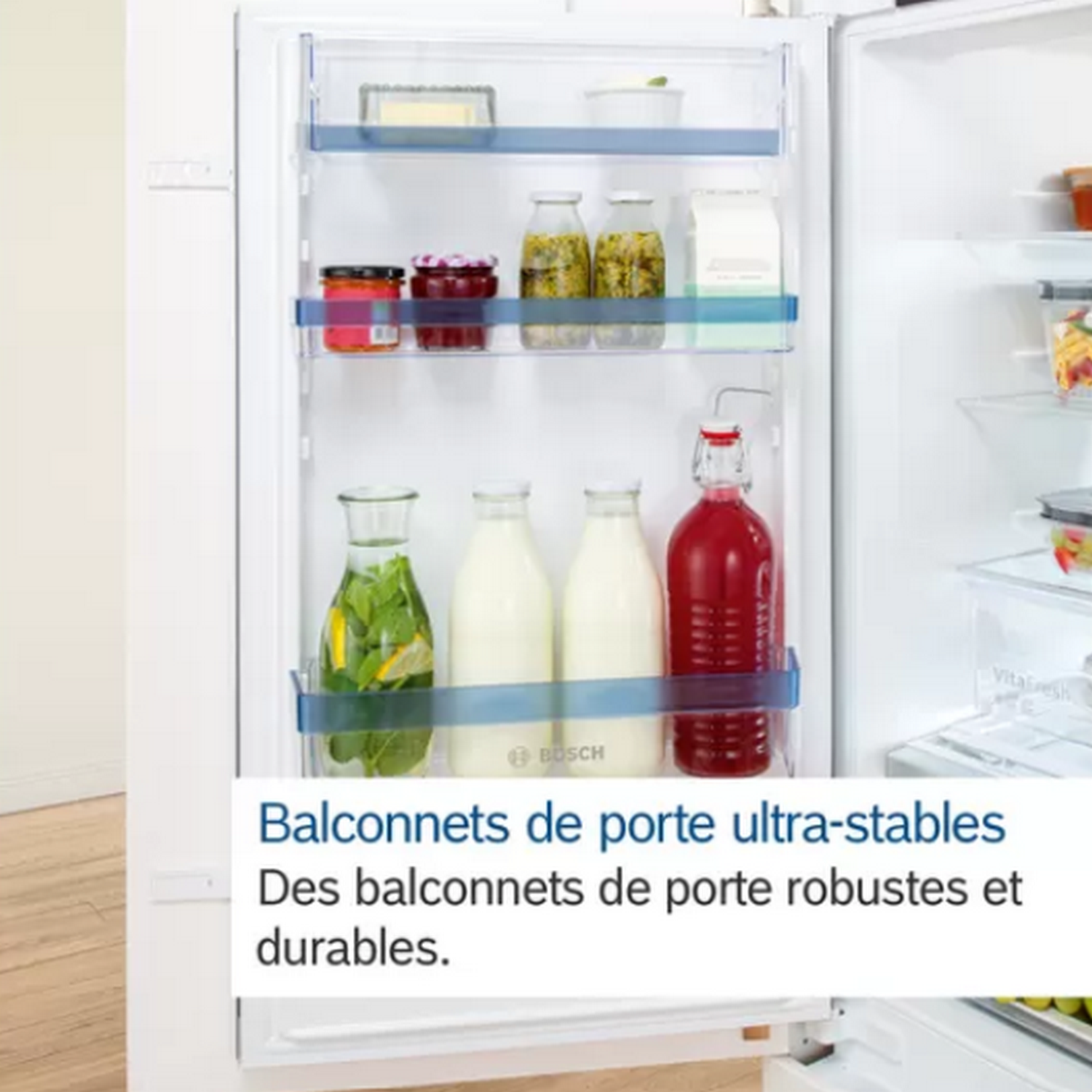 Inside of a refrigerator with shelves of food and text in French at the bottom.