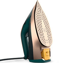 Zielono-złote żelazko z wieloma otworami na białym tle.