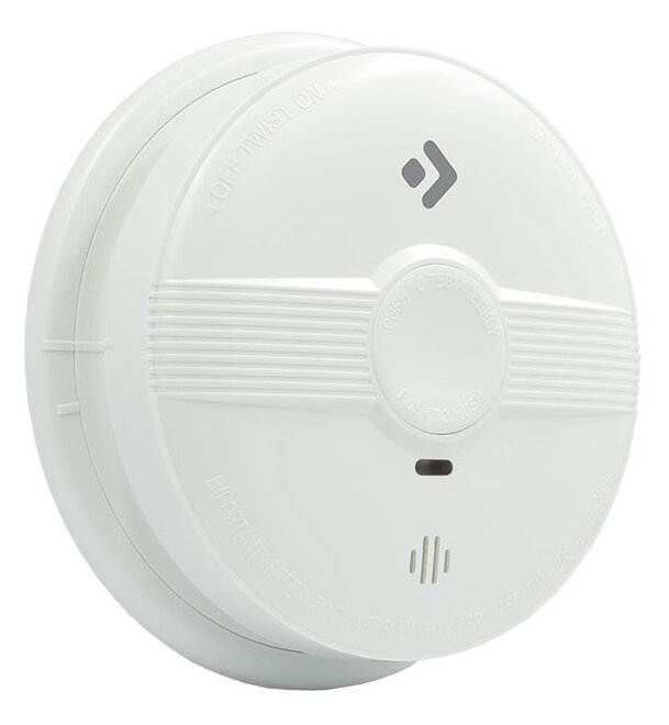 Biały czujnik dymu. Ma przycisk testowy i otwory głośnikowe. Tekst 'PUSH TO TEST'.