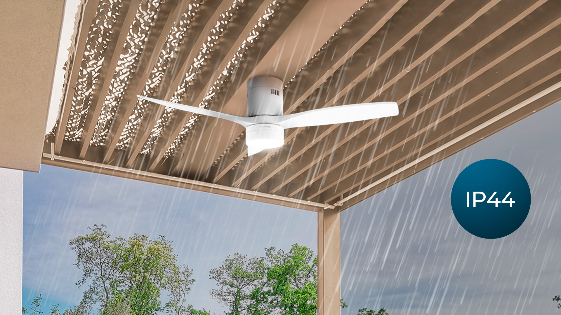 Ventilador de techo blanco con luz bajo estructura sombreada, llueve.