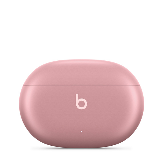 Estuche de carga de auriculares Beats rosa con el logo 'b' blanco. Forma ovalada, tapa cerrada.