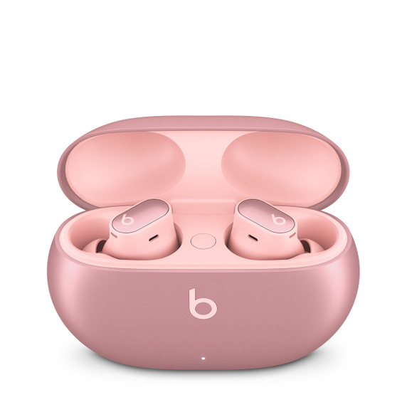 Auriculares Beats rosas en un estuche de carga rosa, abierto.