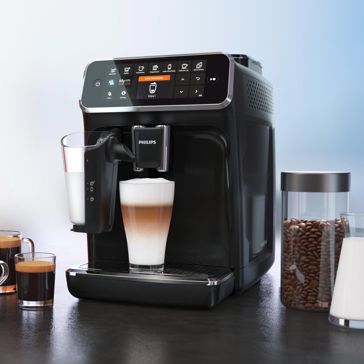 Czarny ekspres do kawy Philips z wyświetlaczem. Szklanka z warstwową kawą, pojemnik na mleko, ziarna kawy.