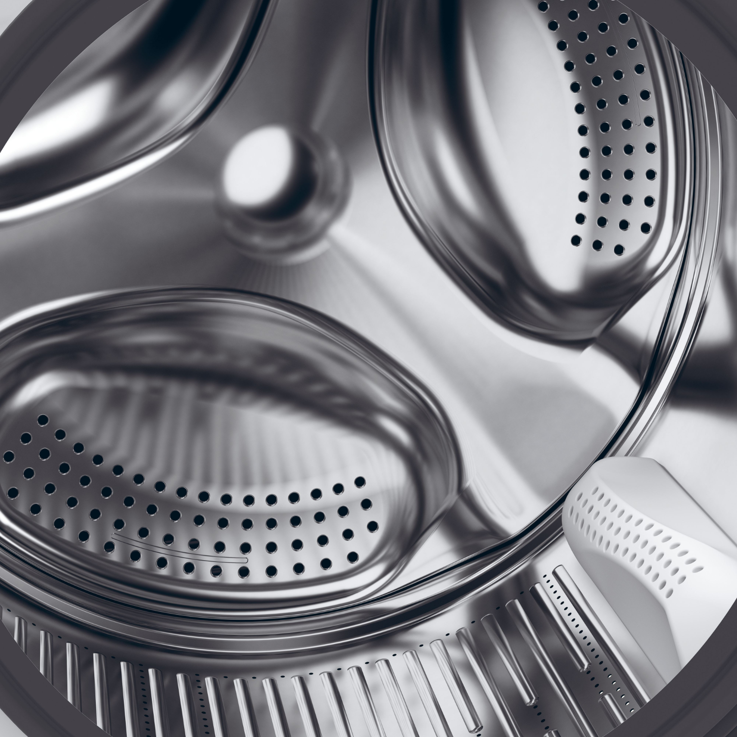 Washing machine drum interior with multiple holes.