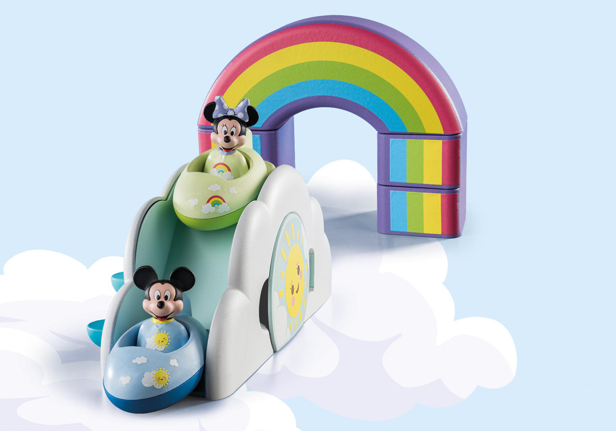 Playmobil Mickey und Minnie Mouse auf einer Regenbogenrutsche. Wolkenhintergrund und helle Farben.