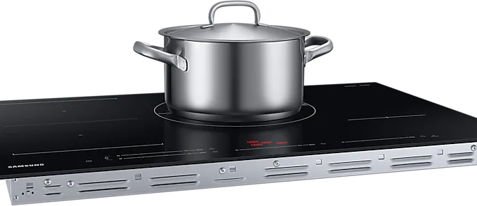 A stainless steel pot on a black induction cooktop.
