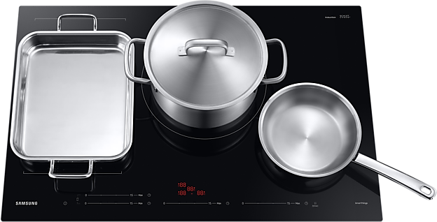 Black induction cooktop with three stainless steel pots on it. Digital display visible.