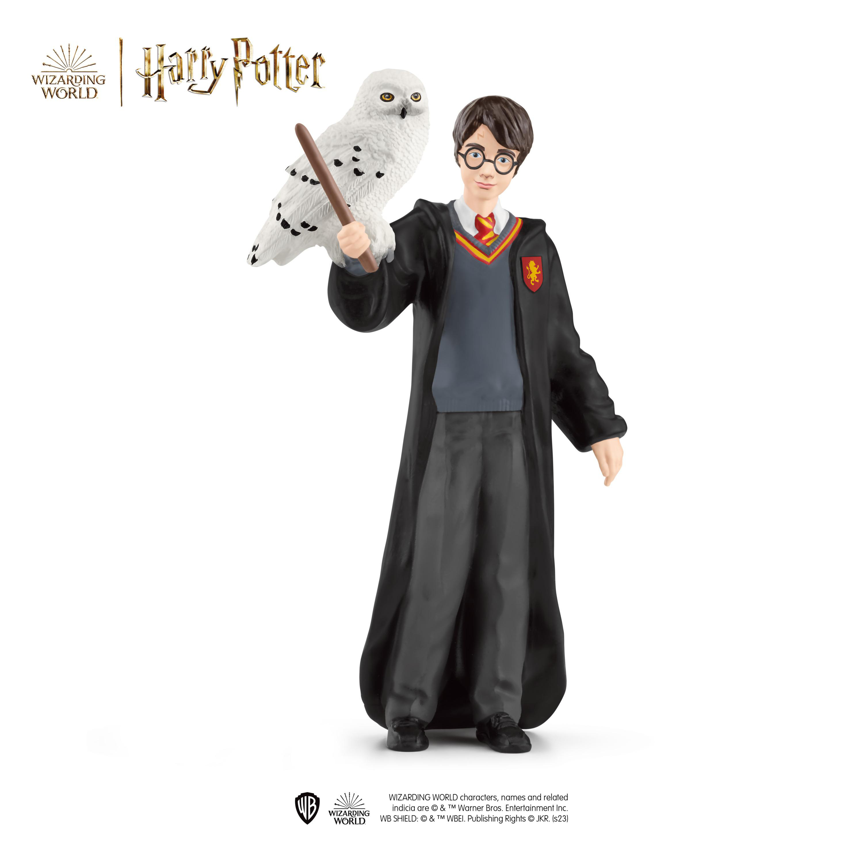 Harry Potter Figur mit Zauberstab, mit einer Eule auf der Schulter.
