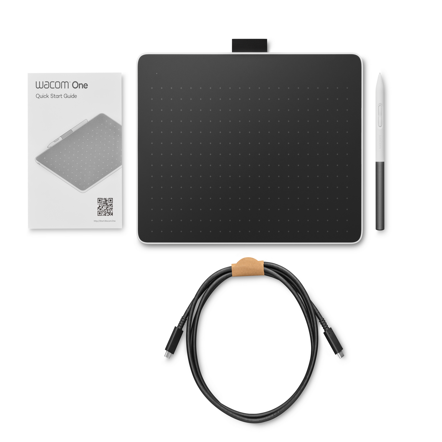 Wacom One drawing tablet, pen, cable, and manual on a white surface. All items are new.