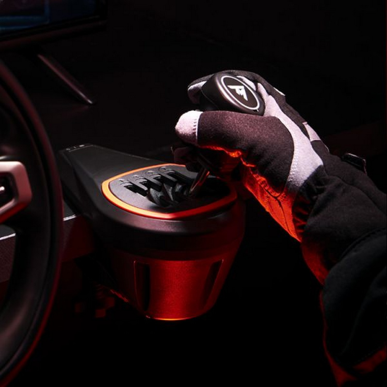Close-up of a hand in a black and white glove, shifting a car's gear stick. The background is dark.
