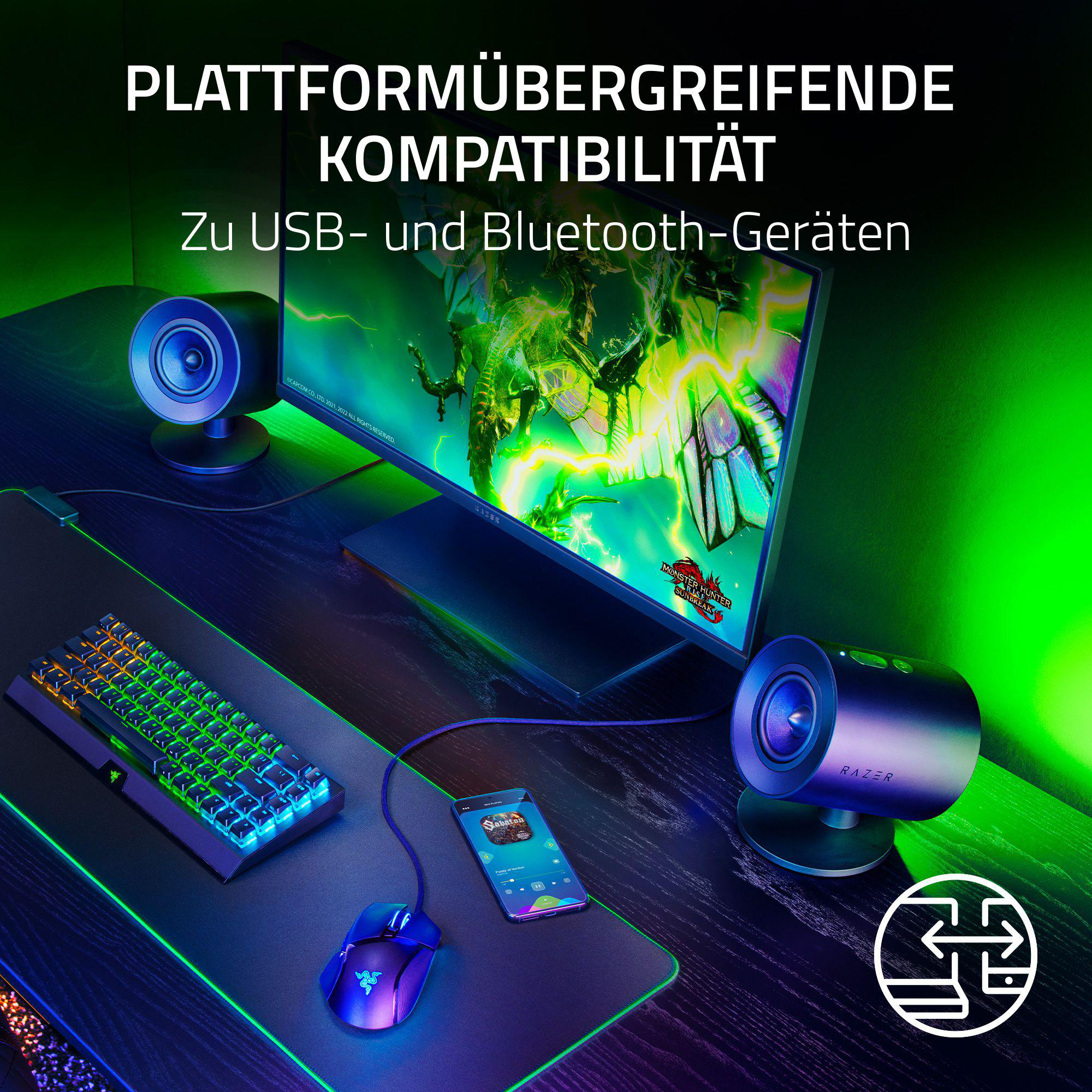 Ein Schreibtisch-Setup mit Monitor, Lautsprechern, Tastatur und Maus mit Telefon.