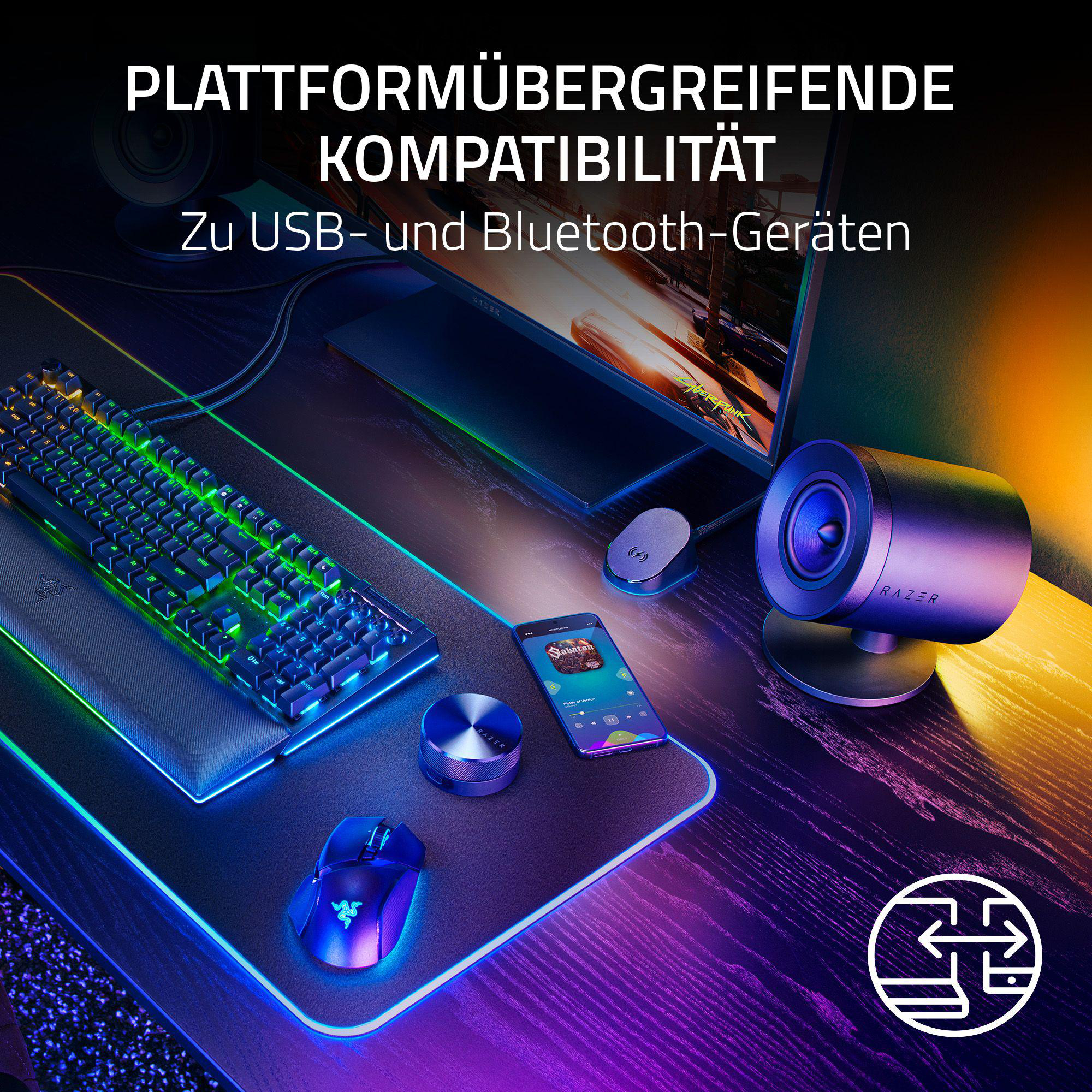 Gaming-Setup mit Tastatur, Maus und Lautsprechern auf einem Schreibtisch mit Neonlichtern.