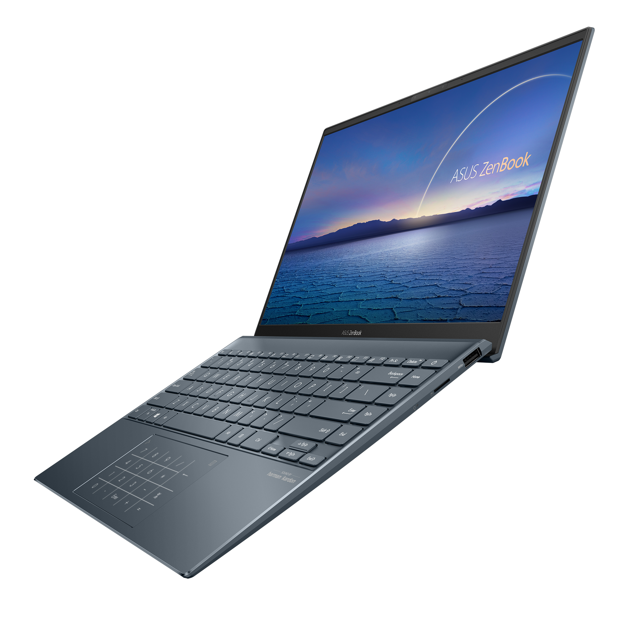 Laptop ASUS Zenbook, abierto, vista en ángulo. Muestra la pantalla con un paisaje y teclado.