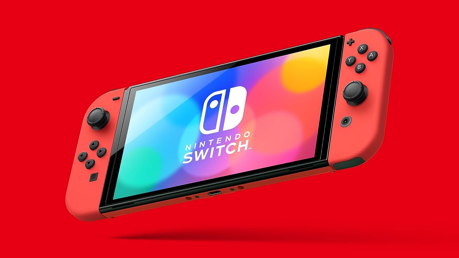 Una Nintendo Switch roja con mandos rojos sobre un fondo rojo, en ángulo ascendente.