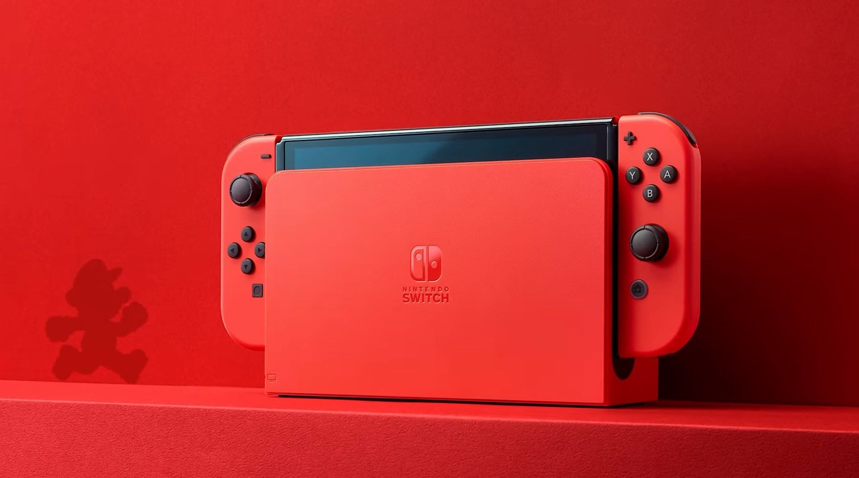 Nintendo Switch rojo con mandos y base, sombra de Mario.