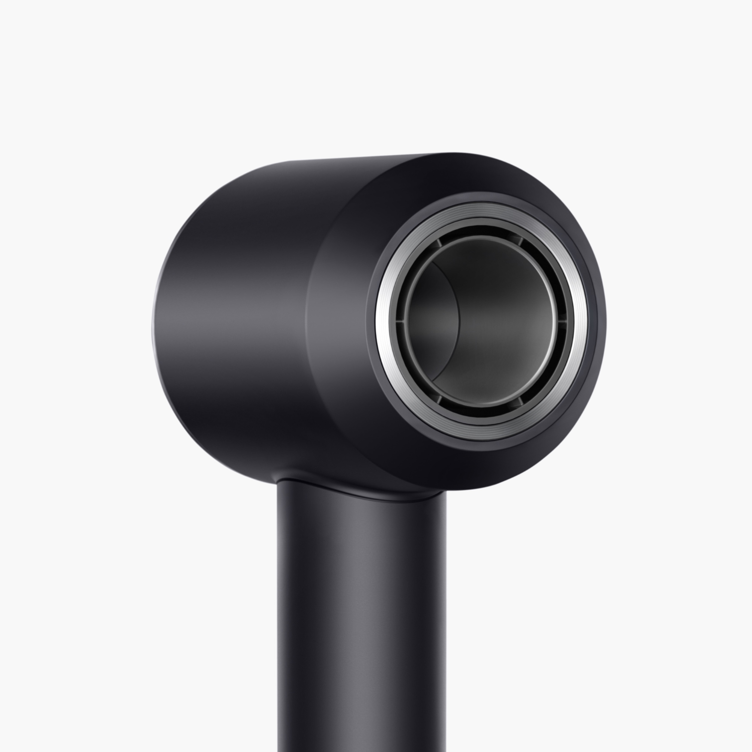 Close-up of a black Dyson hairdryer. The nozzle and handle are visible against a white background.
