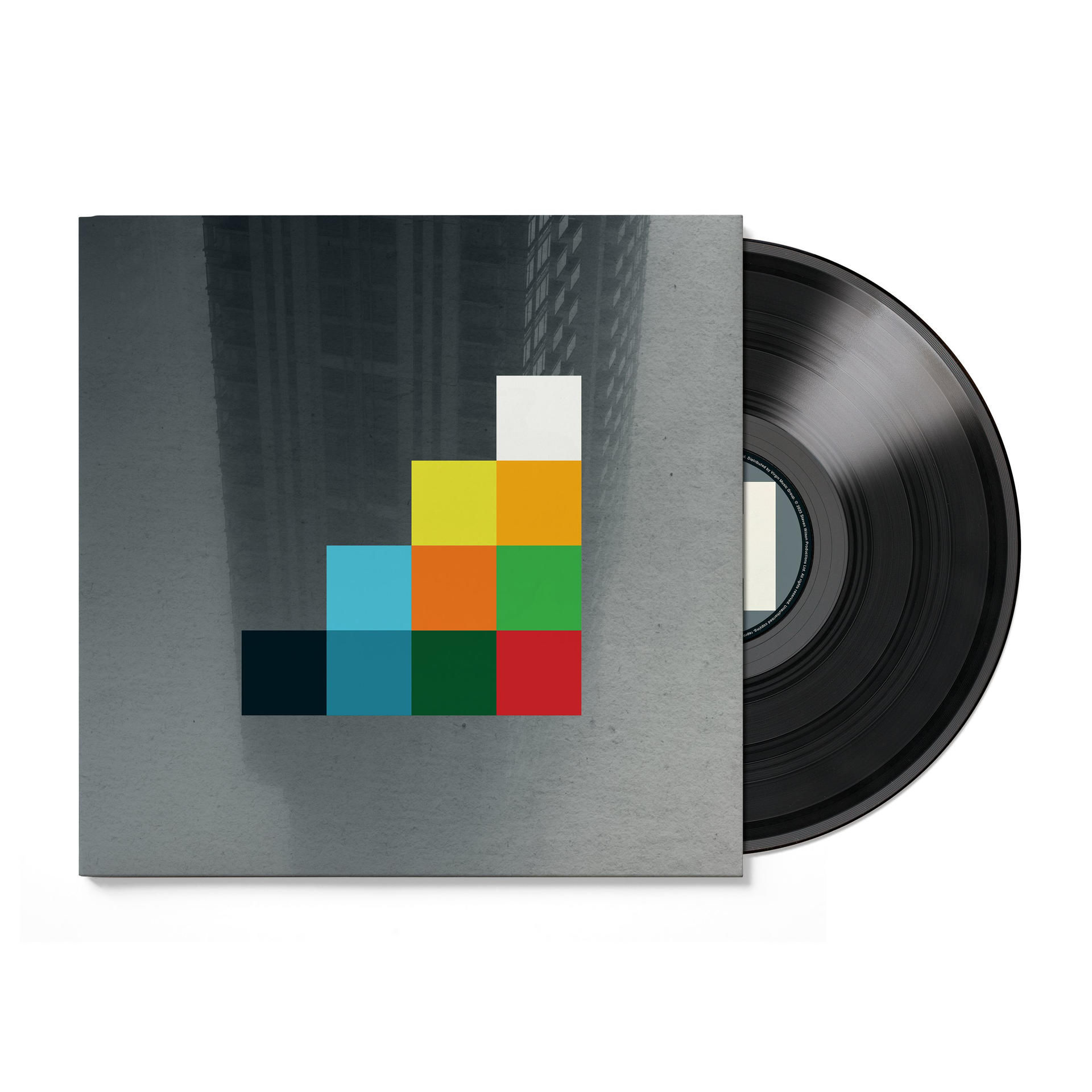 Ein Vinyl-Album mit einem farbenfrohen geometrischen Design neben der Schallplatte.