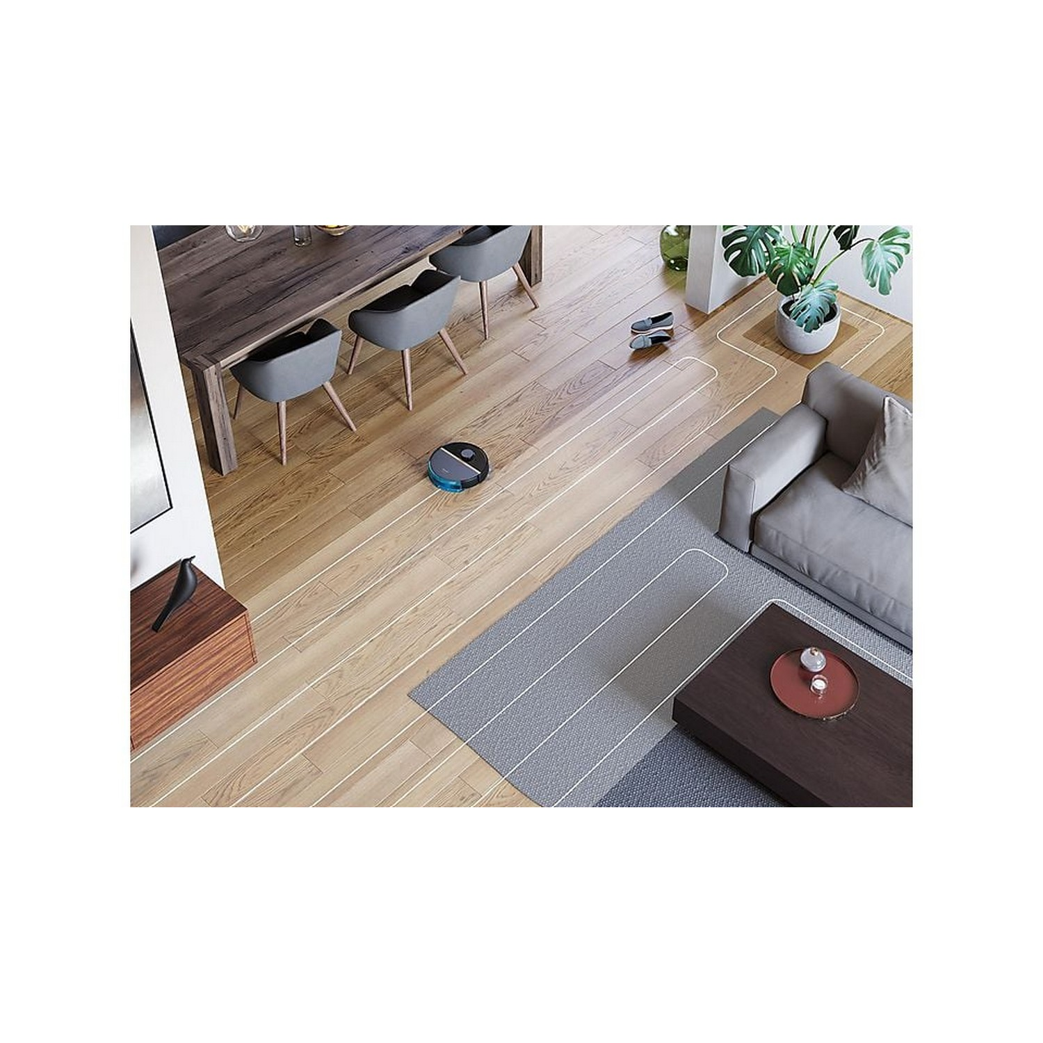 A robot vacuum cleaner cleaning a wooden floor with a white path.