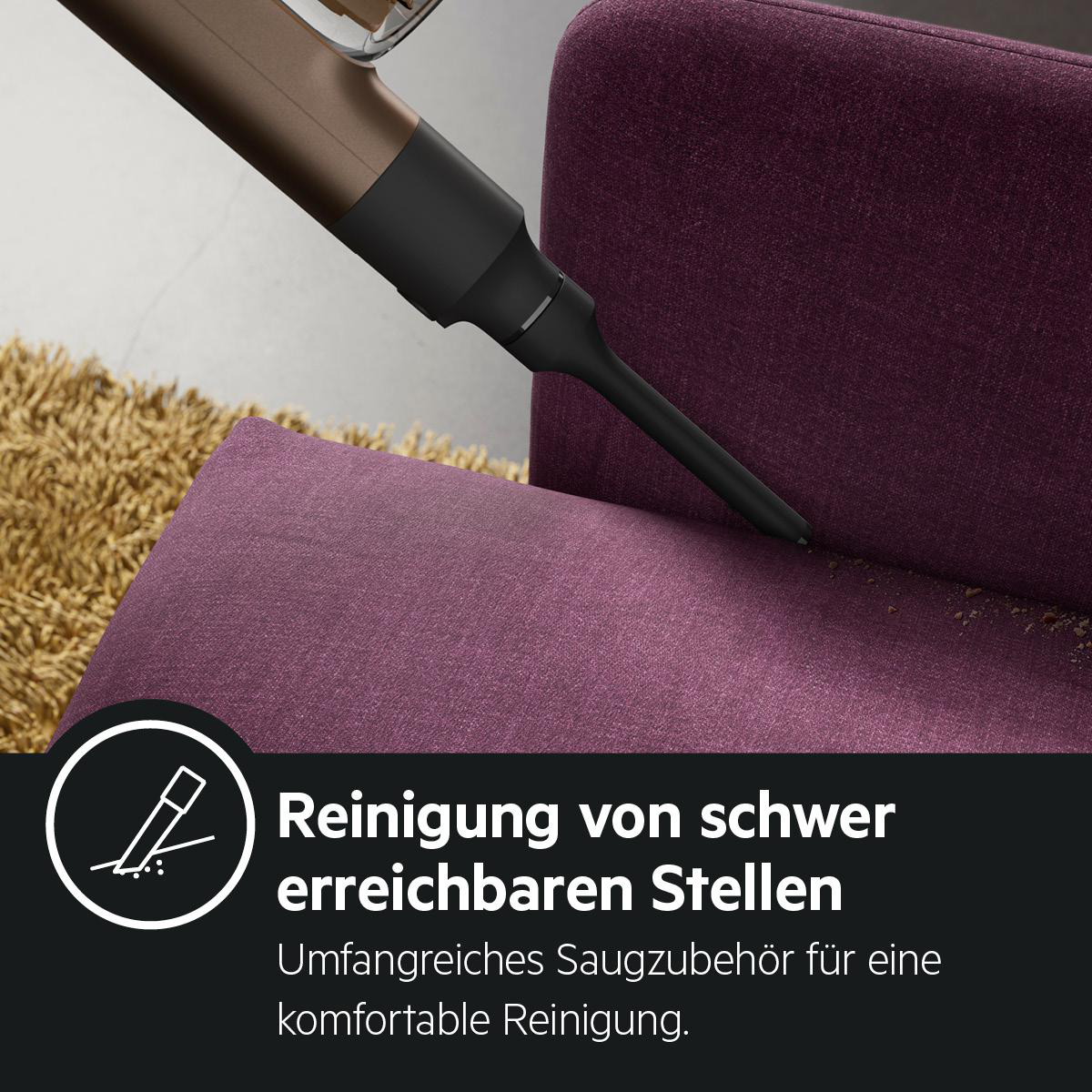 Staubsaugerkopf auf lila Sofa. Text: 'Reinigung von schwer erreichbaren Stellen'.