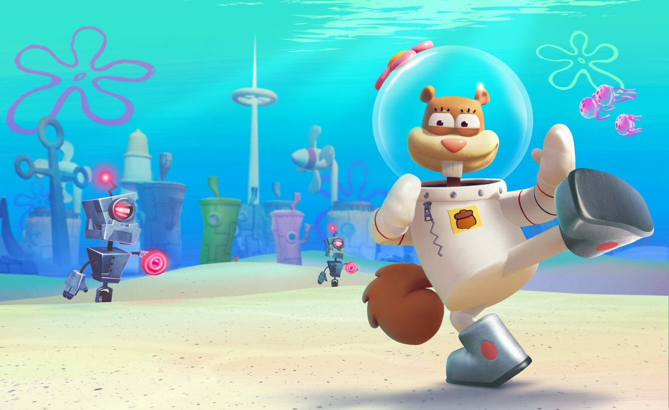 Sandy Cheeks w skafandrze kosmicznym tańczy przed podwodnym miastem.
