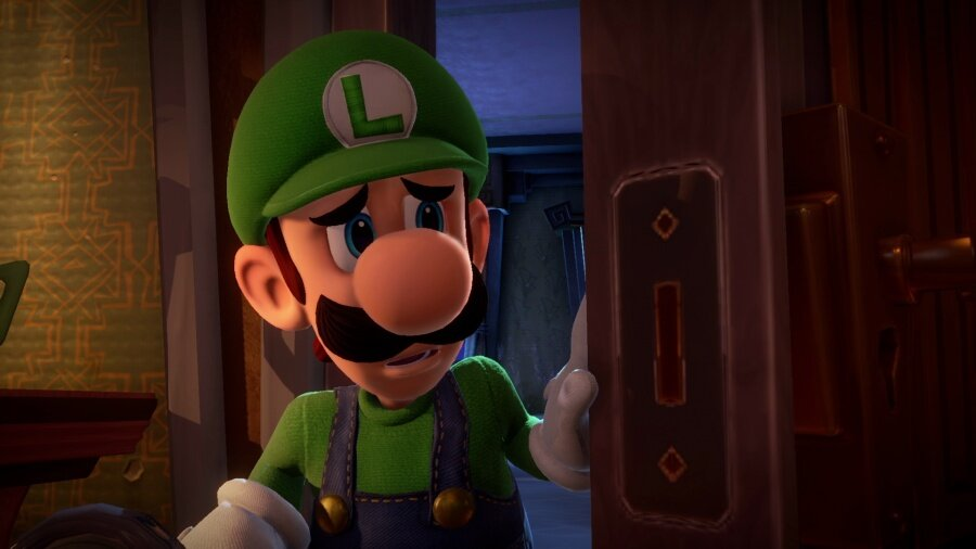 Luigi z Luigi's Mansion zmartwiony trzyma otwarte drzwi. Ciemne wnętrze.