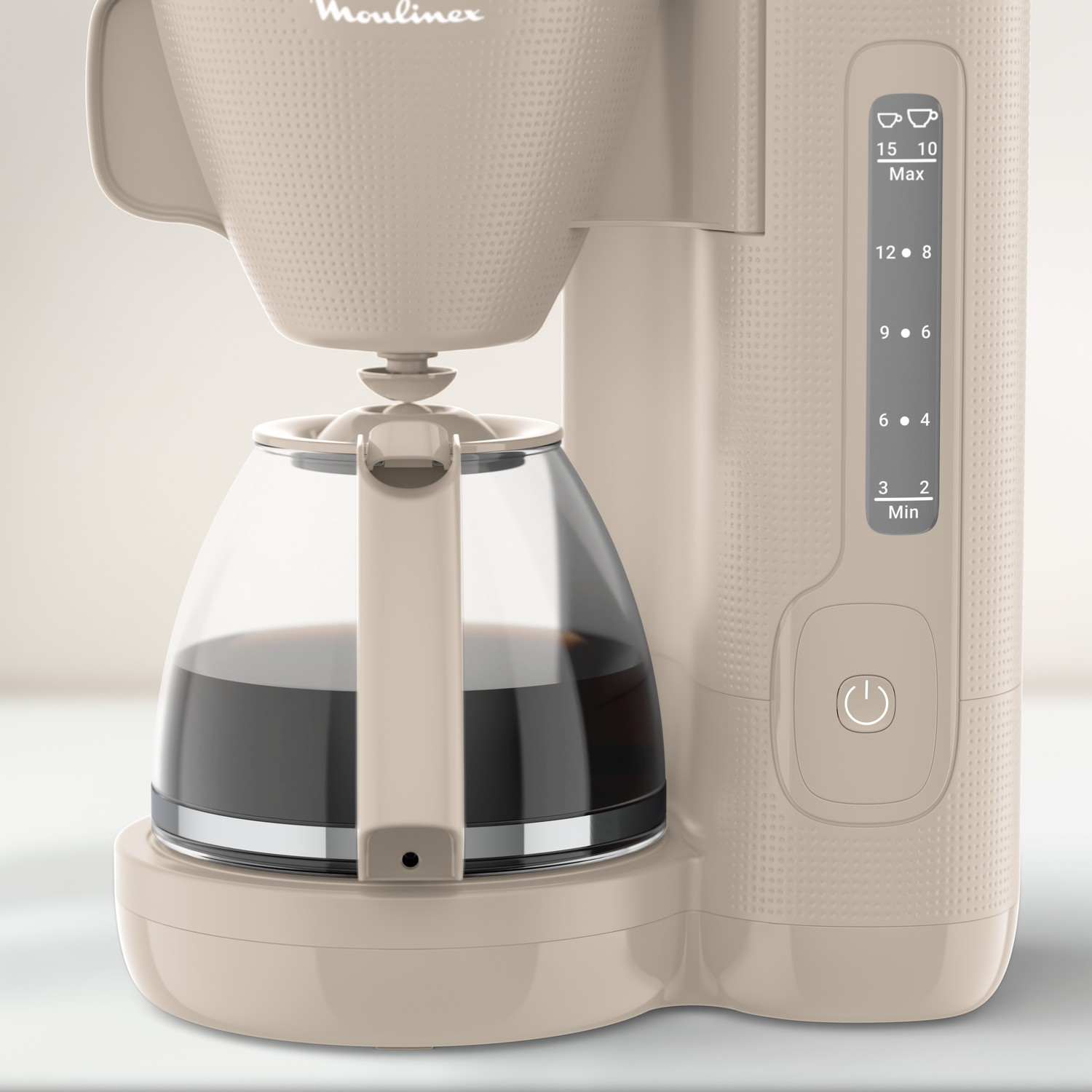 A beige Moulinex coffee maker. It has a glass carafe with coffee and a control panel on the right.