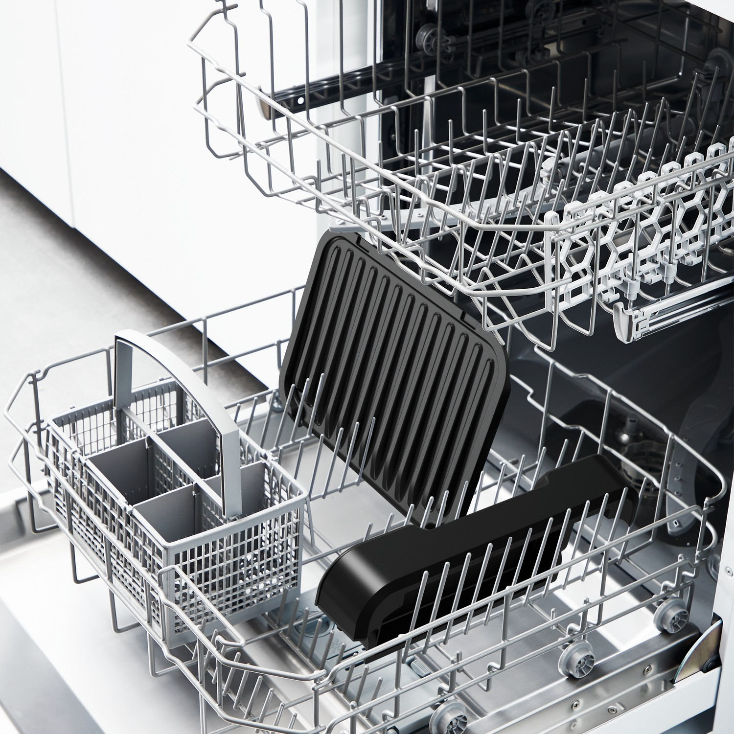 A dishwasher with a black grill pan and a utensil holder inside. The machine is open.