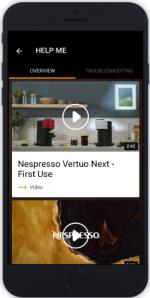 Egy okostelefon képernyője, amely egy 'Nespresso Vertuo Next - First Use' című videót jelenít meg lejátszás gombbal.