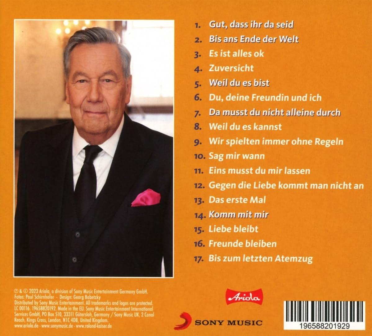 Rückseite einer CD mit einem Mann im Anzug und einer Titelliste auf der rechten Seite.