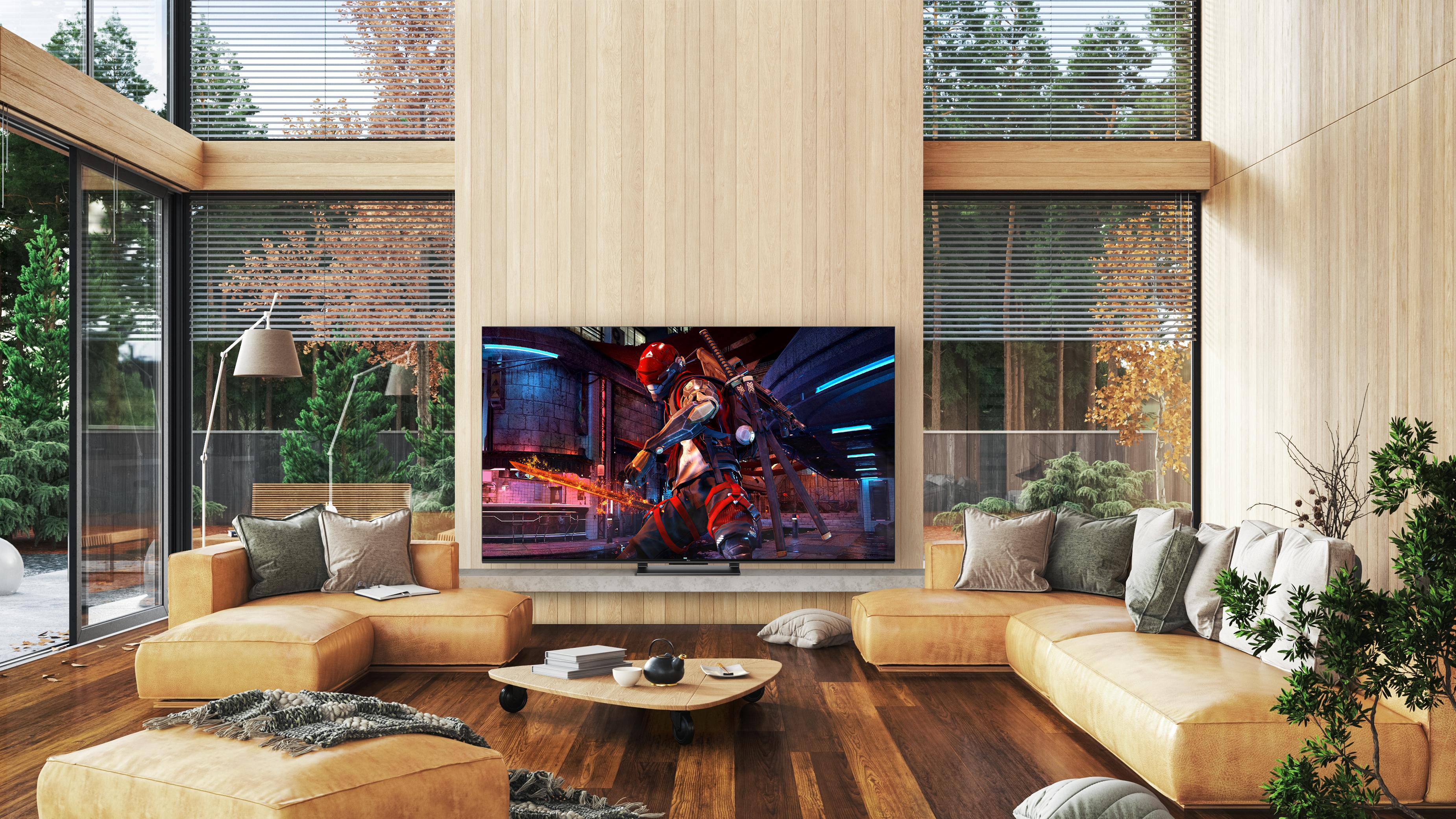 Modernes Wohnzimmer mit großem TV, zeigt Spielszene, Sofas und Couchtisch.