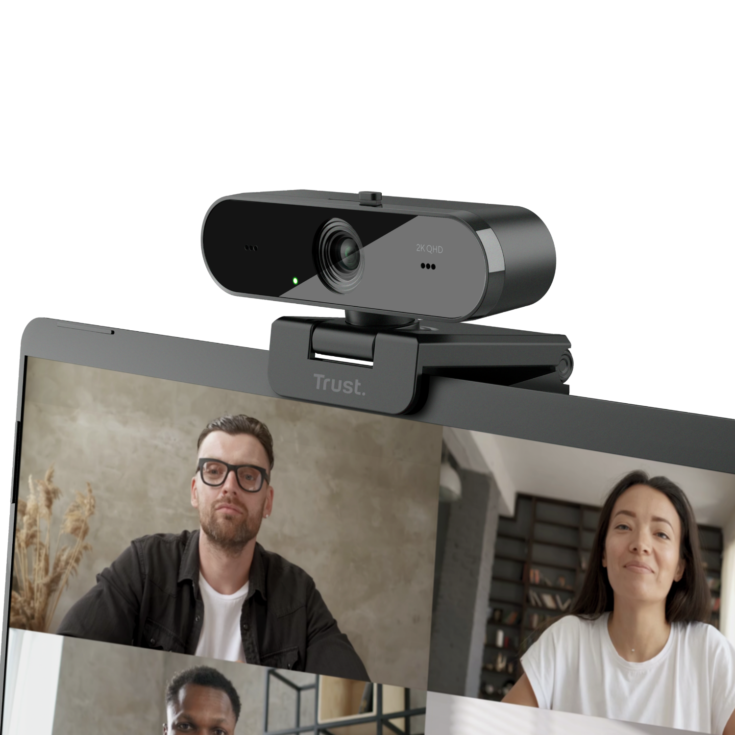 Webcam on top of a laptop screen showing a video call with three people.