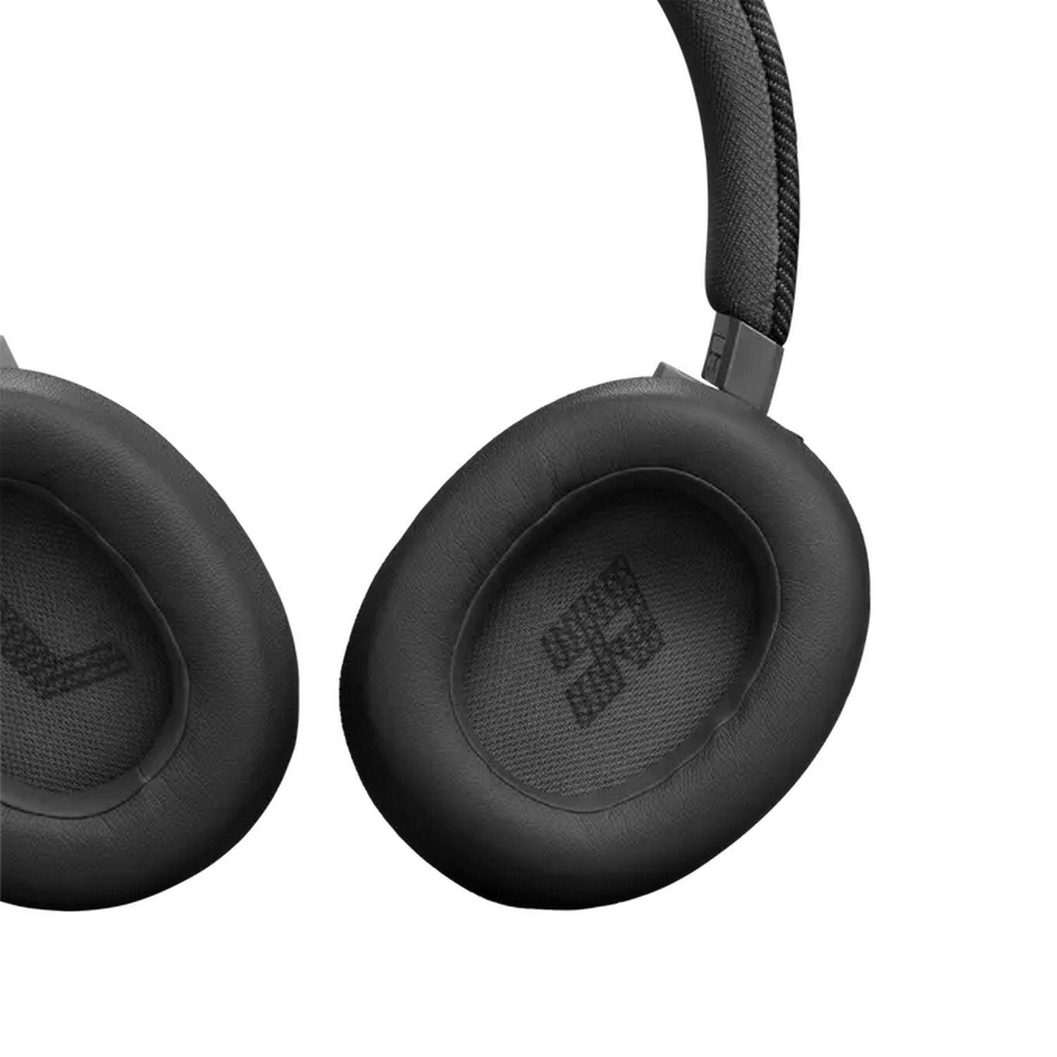 Close-up of black headphone earcups with a logo on the inside.