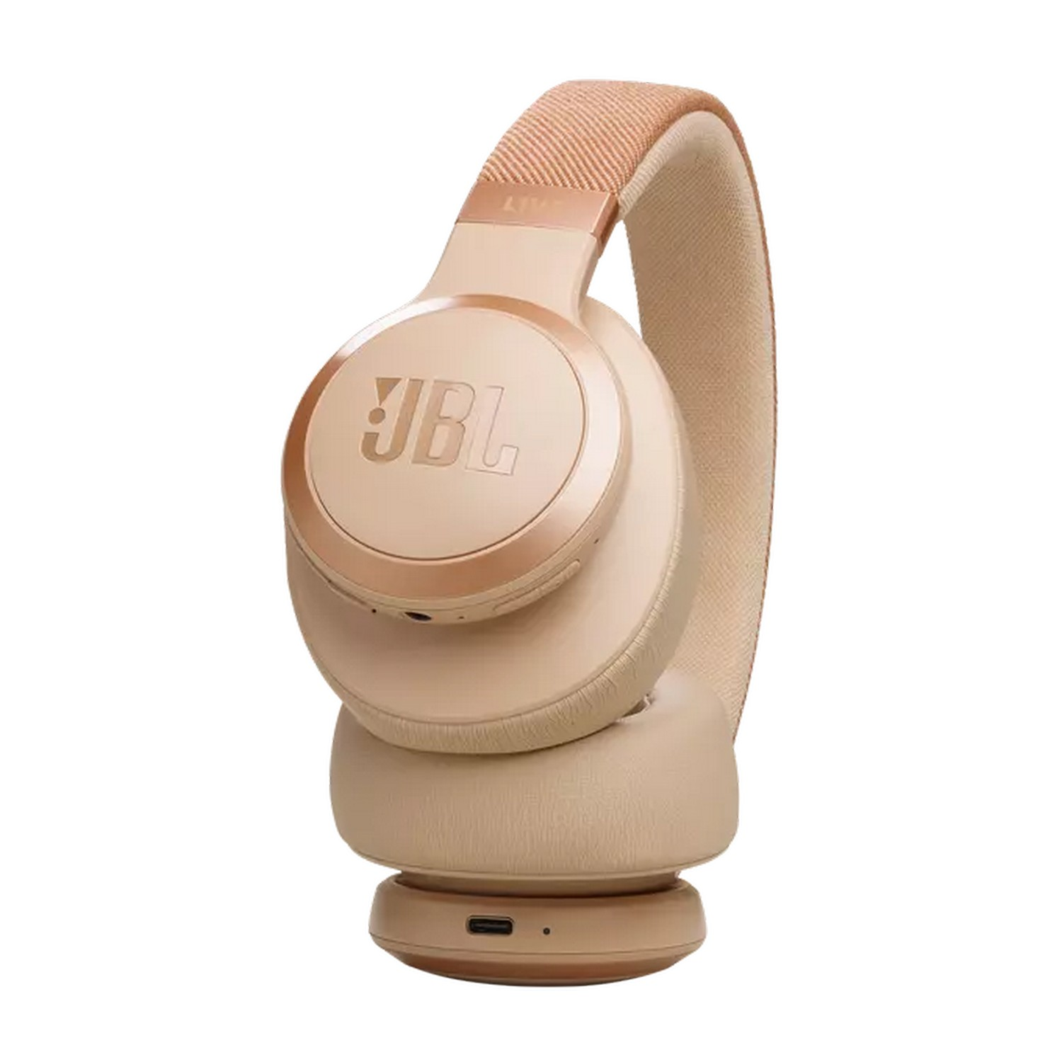 Beige JBL headphones. The band and earcups are in the same color, the brand logo is visible.