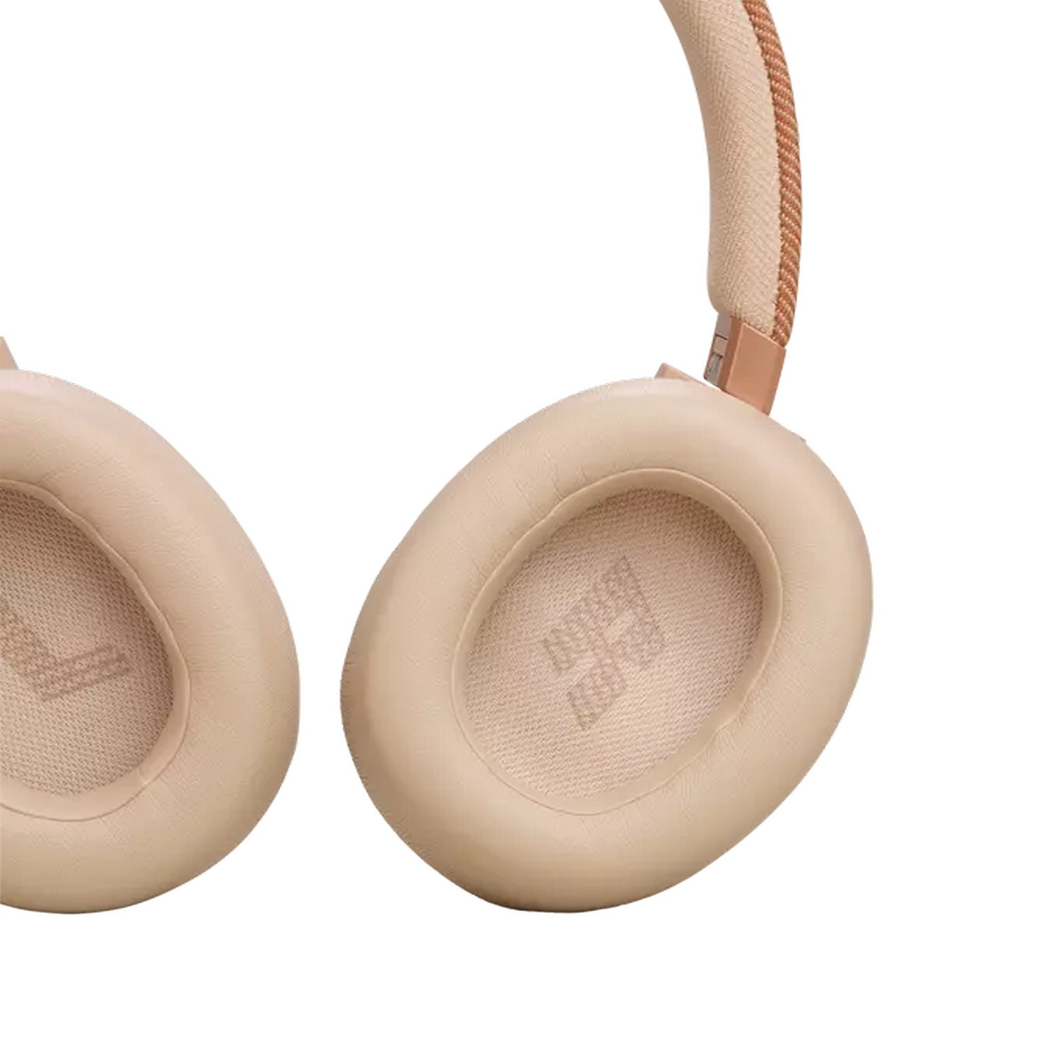 Close-up of light beige headphones with a tan headband and rose gold accents.