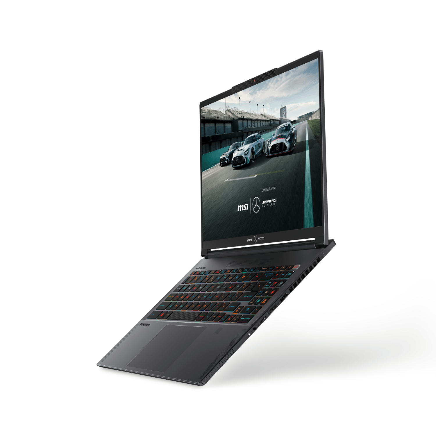 Laptop negro con pantalla que muestra autos en pista. El teclado es multicolor.