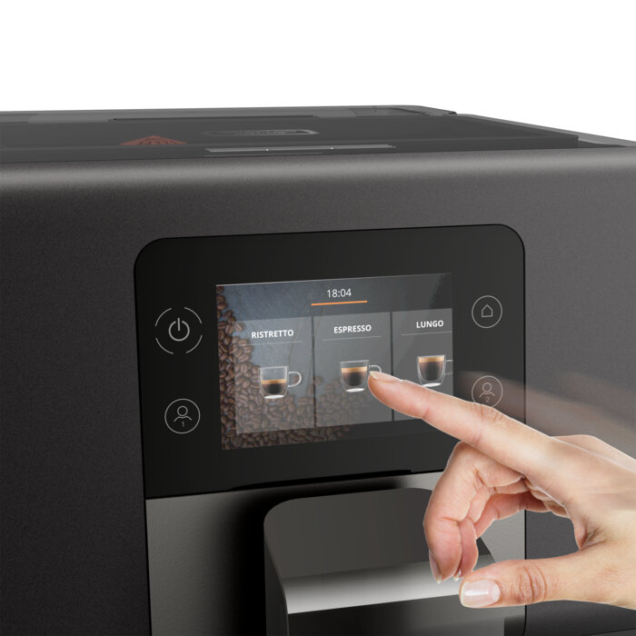 Dłoń dotykająca przycisku espresso na ekranie czarnego ekspresu do kawy, pokazująca opcje.