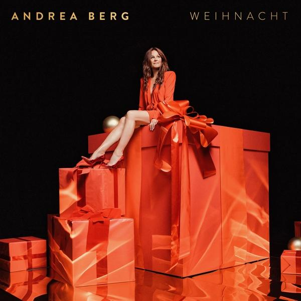 Andrea Berg Albumcover. Frau in rotem Kleid auf roten Geschenkboxen. Schwarzer Hintergrund mit Golddetails.