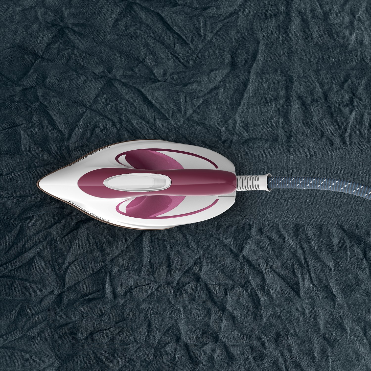 A steam iron, top view, on a dark blue wrinkled fabric.