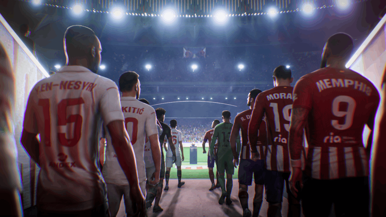 Jugadores de fútbol caminando por un túnel hacia un estadio brillantemente iluminado. Multitud al fondo.