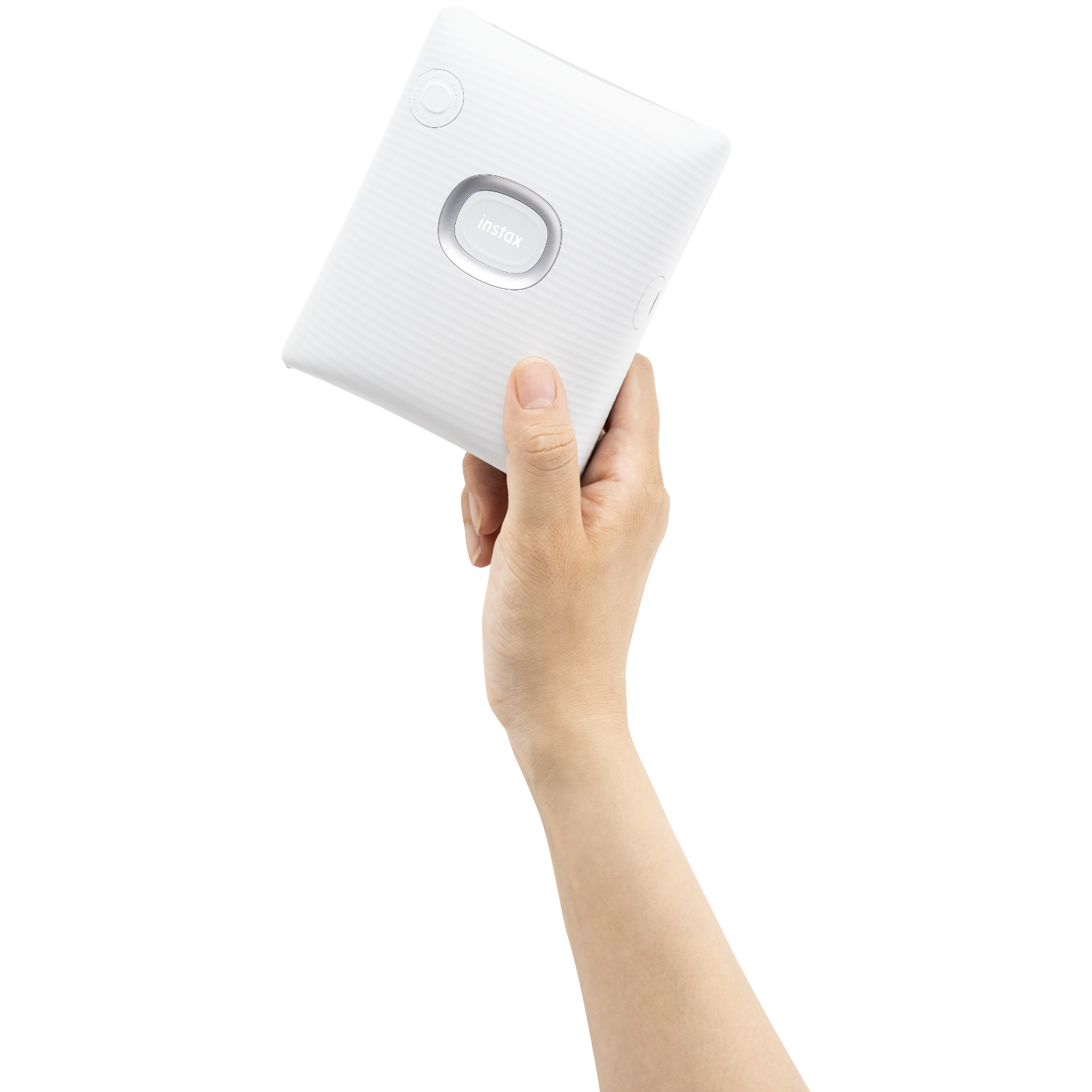 A hand holding a white Instax printer. The Instax logo is visible.