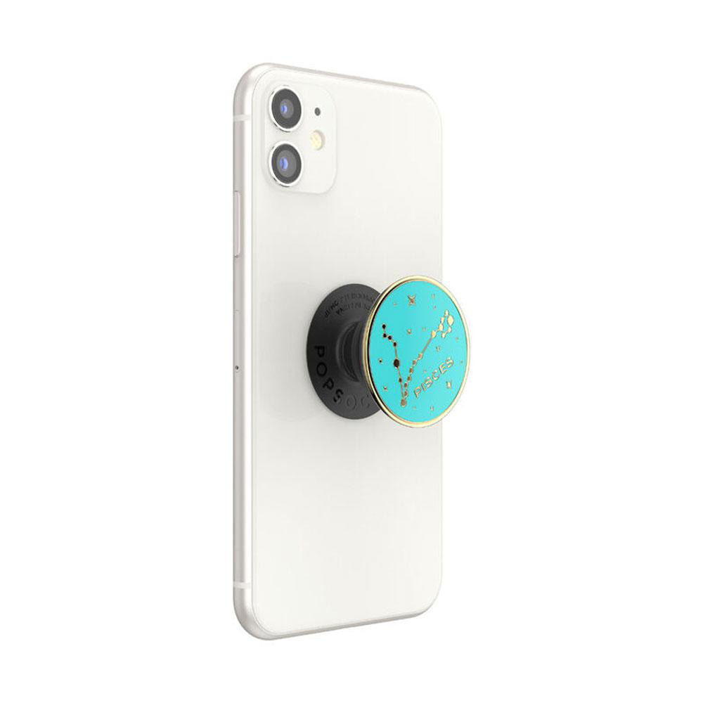 Weißes Telefon mit PopSocket. Das PopSocket hat einen türkisfarbenen Hintergrund mit Sternzeichen.