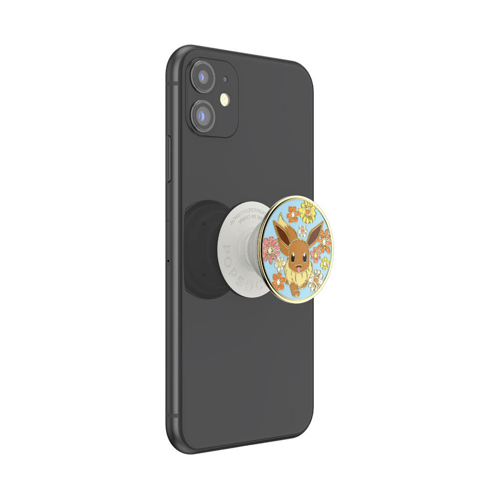 Schwarzes Handy mit PopSockets-Halterung. Der Halter zeigt Eevee auf blumigem Muster.