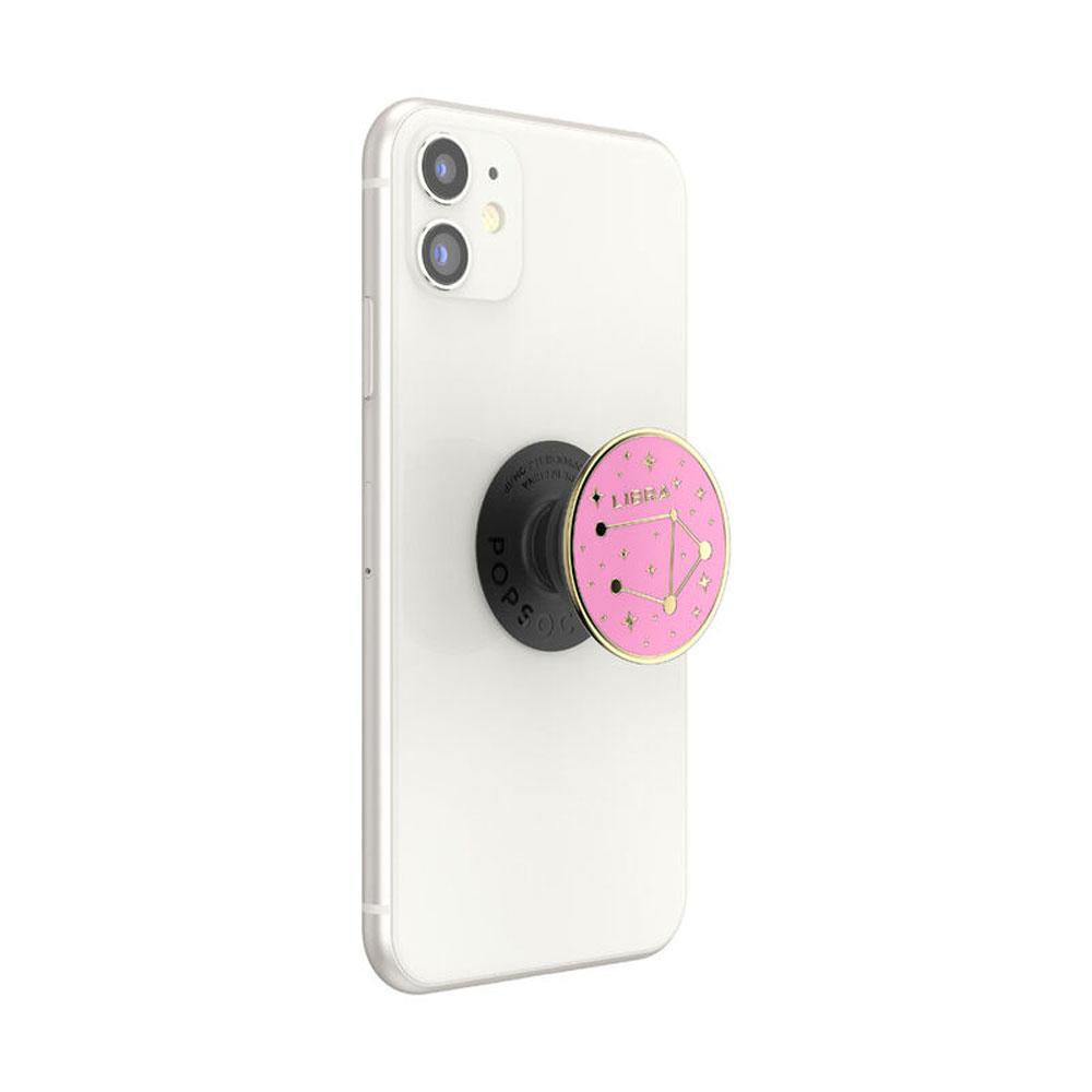 Weißes Telefon mit einem Pop-Socket mit einem rosa Waage-Design.
