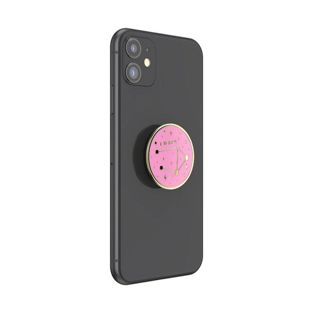Schwarzes iPhone mit einem rosa Libra Pop-Socket.