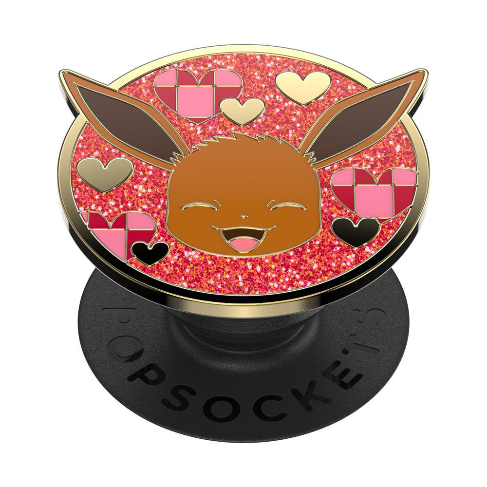 PopSockets mit Evoli-Design, goldenen Details und Herzen. Der Hintergrund ist glitzernd rosa.